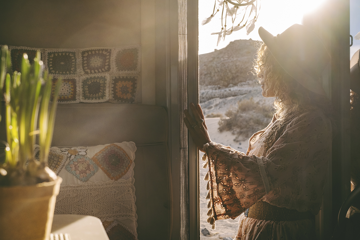 Woman enjoying the warmth and comfort of her home, highlighting heating and air efficiency.